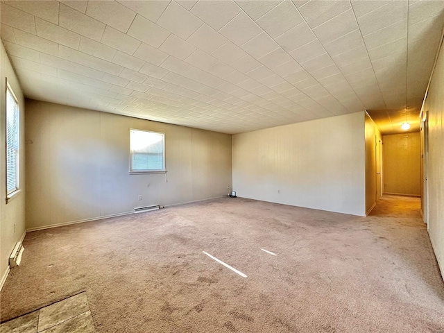 empty room with carpet floors and a baseboard radiator