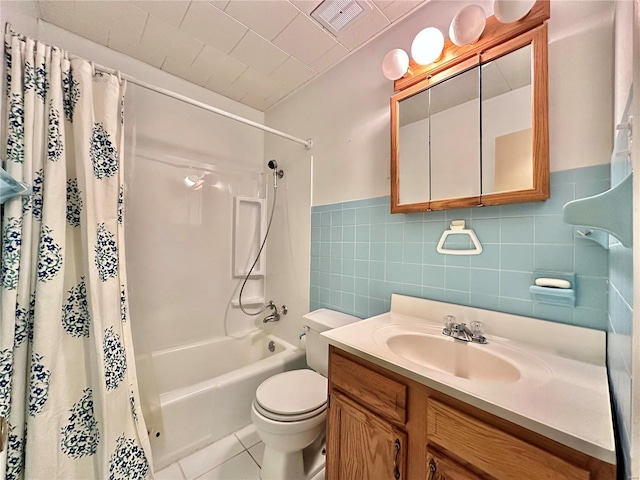 full bathroom featuring vanity, tile patterned floors, toilet, shower / bathtub combination with curtain, and tile walls