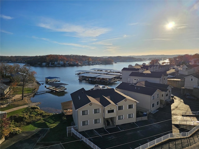 aerial view at dusk featuring a water view