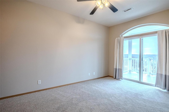 carpeted spare room featuring ceiling fan