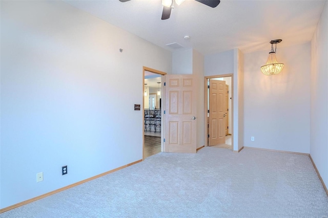 unfurnished room with ceiling fan with notable chandelier and light carpet