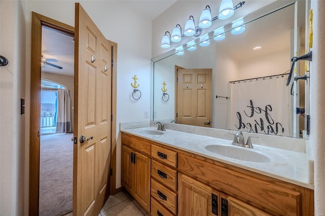 bathroom featuring tile patterned floors, a shower with curtain, ceiling fan, and vanity