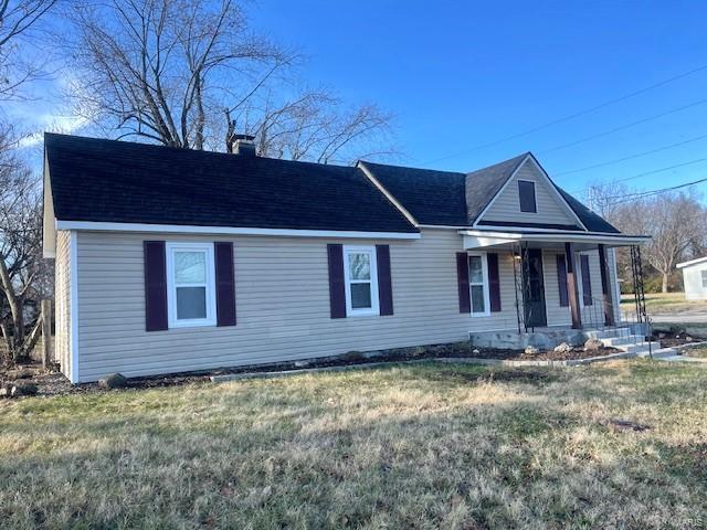 view of front of house with covered porch and a front yard