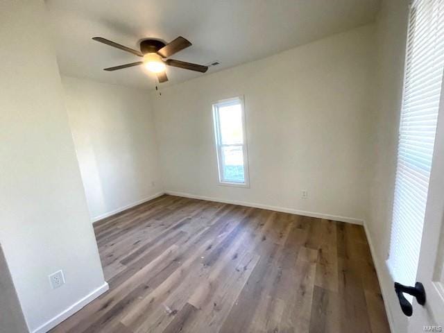 spare room with wood-type flooring and ceiling fan