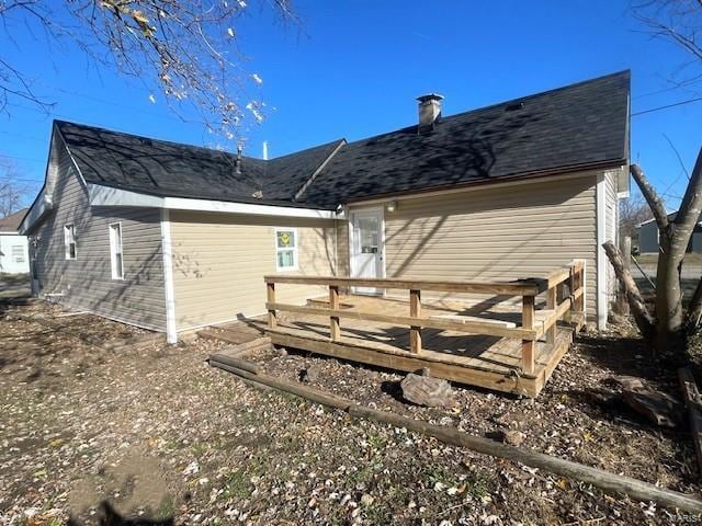 back of house featuring a wooden deck