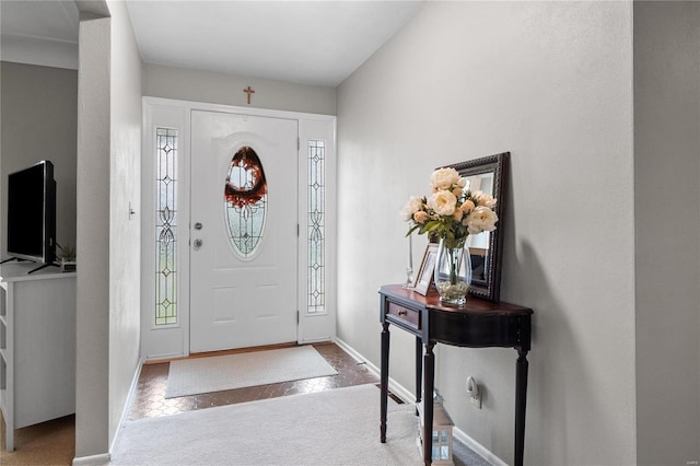 view of carpeted foyer entrance