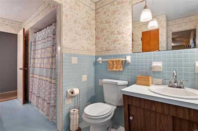 bathroom with vanity, tile patterned flooring, a shower with shower curtain, toilet, and tile walls