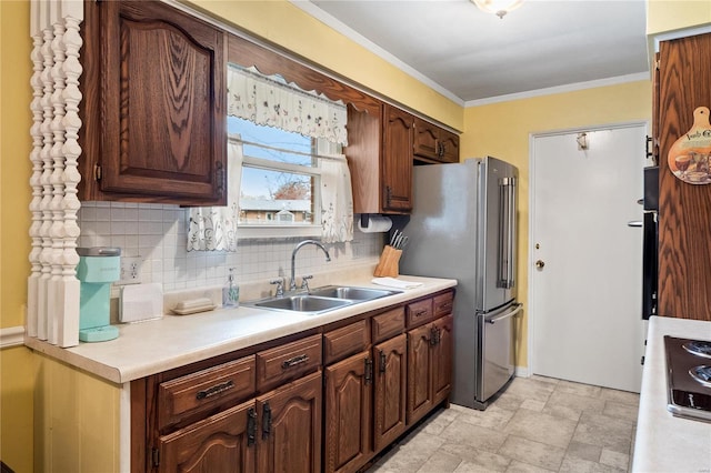 kitchen featuring crown molding, sink, decorative backsplash, high quality fridge, and dark brown cabinets