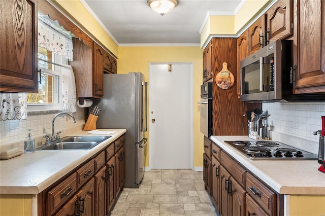 kitchen featuring backsplash, crown molding, sink, and appliances with stainless steel finishes