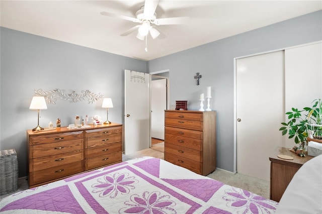 carpeted bedroom featuring a closet and ceiling fan