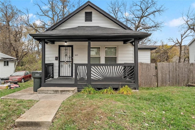 bungalow-style house featuring a front lawn and covered porch