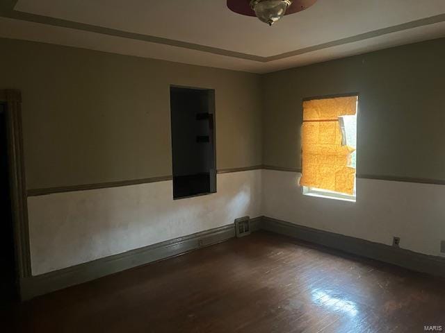 unfurnished room with dark hardwood / wood-style flooring