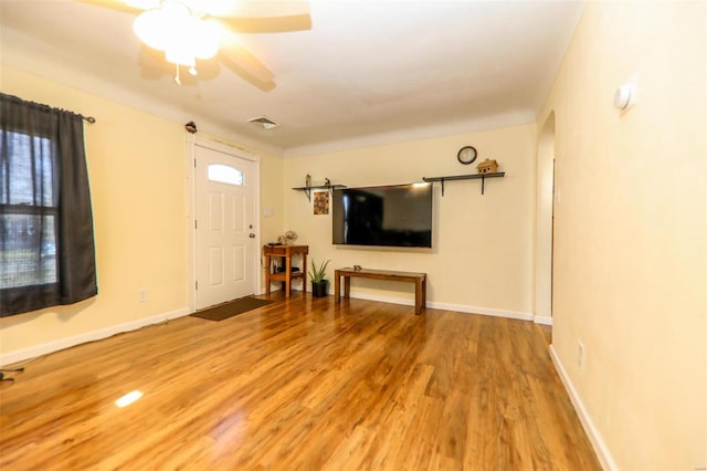 unfurnished living room featuring wood-type flooring and ceiling fan