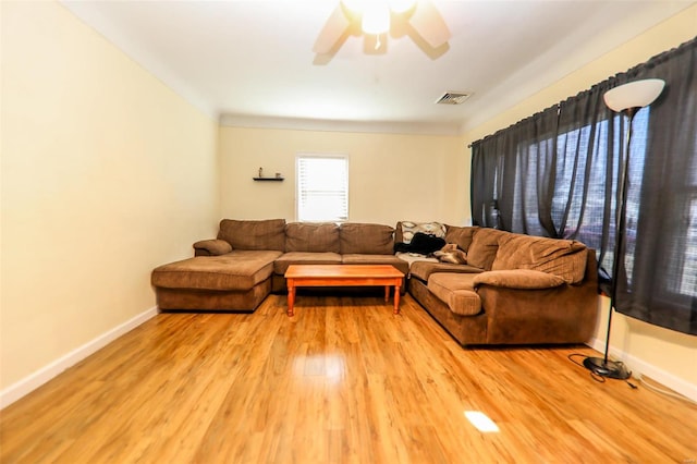 living room with light wood-type flooring and ceiling fan