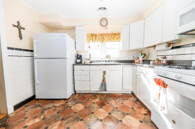 kitchen with white cabinetry, sink, and white appliances