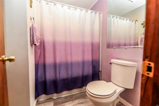 bathroom featuring toilet, wood-type flooring, and walk in shower