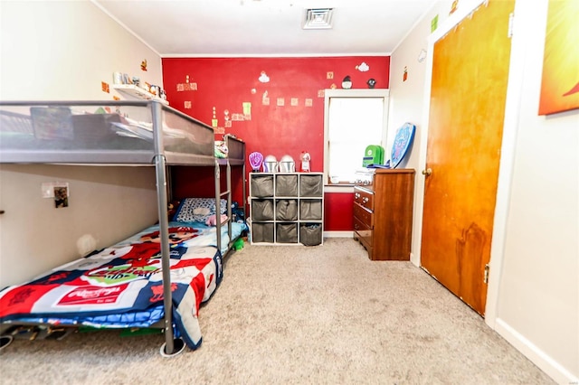 bedroom with crown molding and carpet