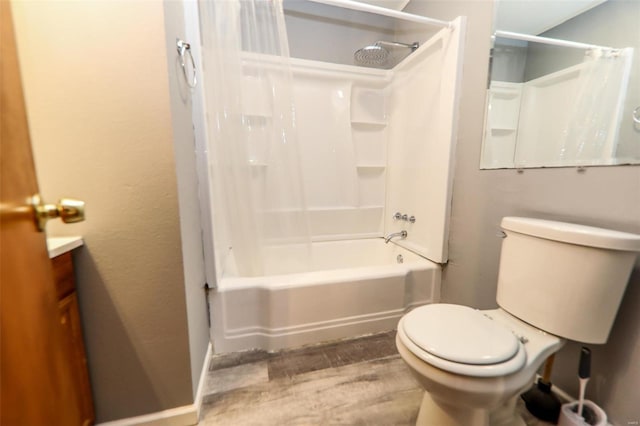 bathroom featuring toilet, shower / bathtub combination with curtain, wood finished floors, and vanity