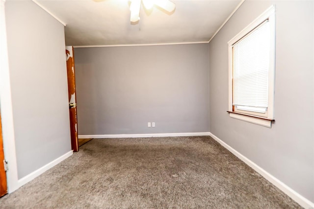 spare room with a ceiling fan, carpet, crown molding, and baseboards