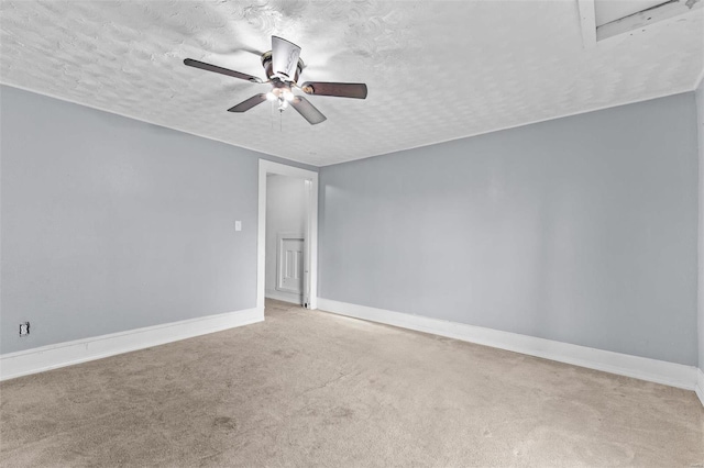 spare room featuring carpet, a textured ceiling, and ceiling fan