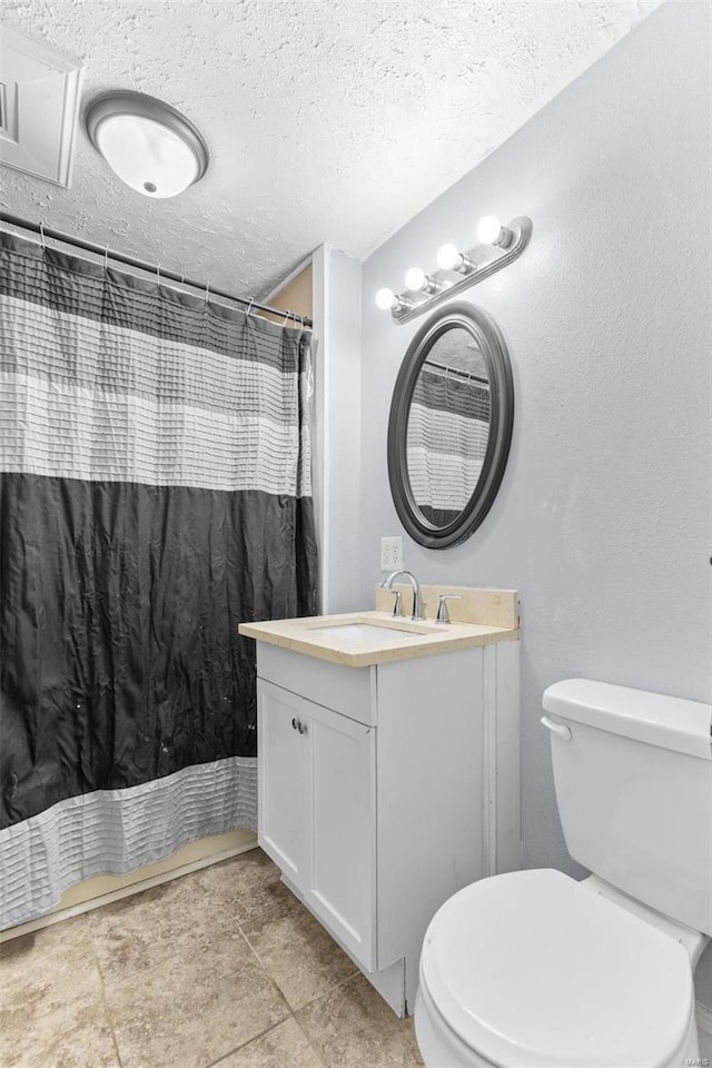 bathroom featuring vanity, a shower with curtain, tile patterned flooring, toilet, and a textured ceiling