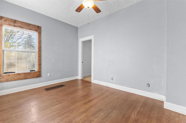 unfurnished room with ceiling fan and hardwood / wood-style floors