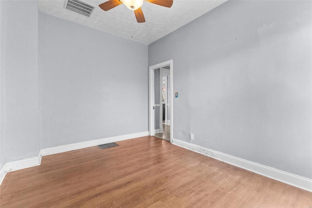 spare room with ceiling fan and hardwood / wood-style flooring