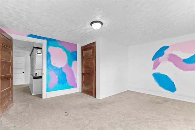 interior space featuring a textured ceiling and light colored carpet