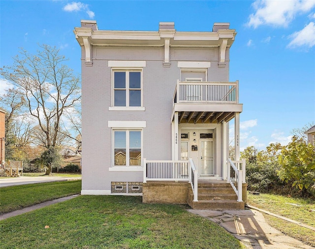 view of front of property featuring a balcony and a front lawn