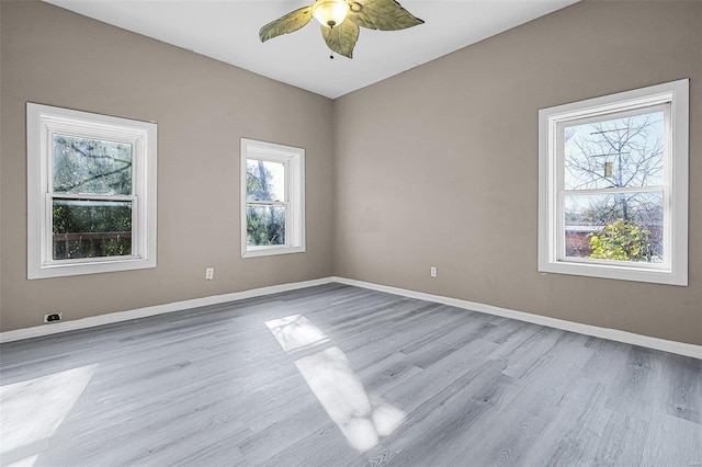 spare room with light wood-type flooring and ceiling fan