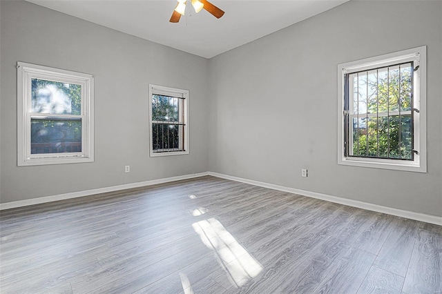 spare room featuring light hardwood / wood-style floors and ceiling fan