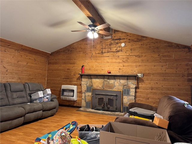 living room with hardwood / wood-style floors, vaulted ceiling with beams, heating unit, and wood walls