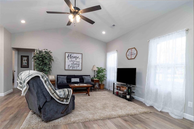 living room with ceiling fan, light wood-type flooring, and lofted ceiling