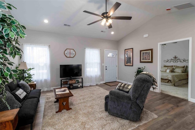 living room with ceiling fan, hardwood / wood-style flooring, and lofted ceiling