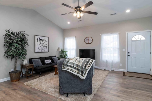 living room featuring lofted ceiling, ceiling fan, and hardwood / wood-style floors