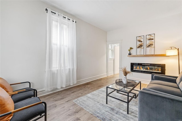 living room featuring plenty of natural light and light wood-type flooring