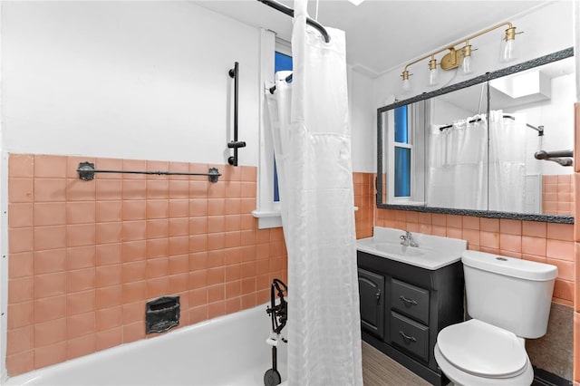 full bathroom featuring vanity, toilet, shower / bathtub combination with curtain, and tile walls