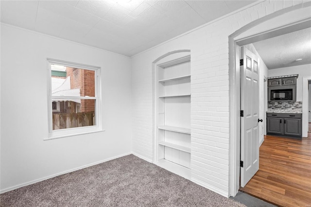 interior space featuring dark colored carpet