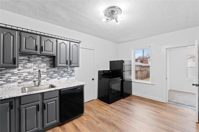 kitchen with gray cabinets, sink, and black appliances