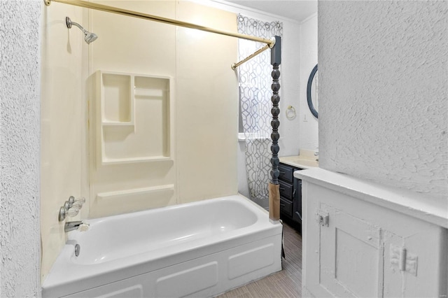 bathroom with tile patterned flooring, vanity, bathing tub / shower combination, and crown molding