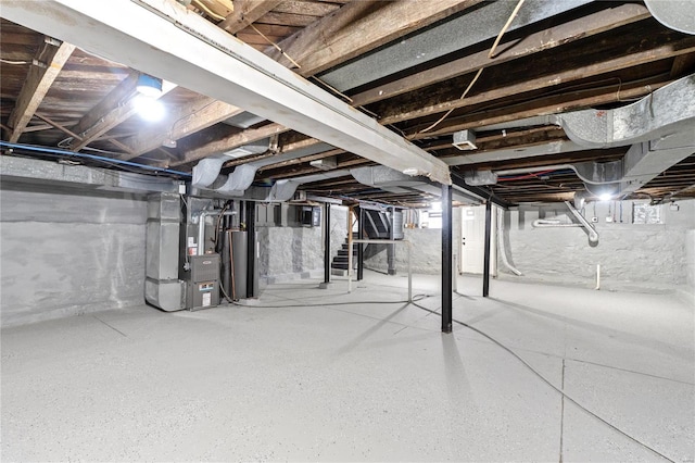 basement featuring heating unit and water heater