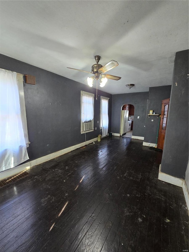 unfurnished living room featuring dark hardwood / wood-style floors, ceiling fan, and cooling unit