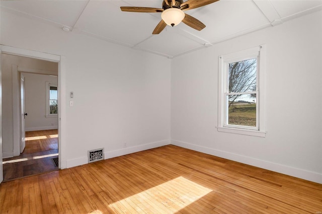 empty room with ceiling fan, a healthy amount of sunlight, and light wood-type flooring