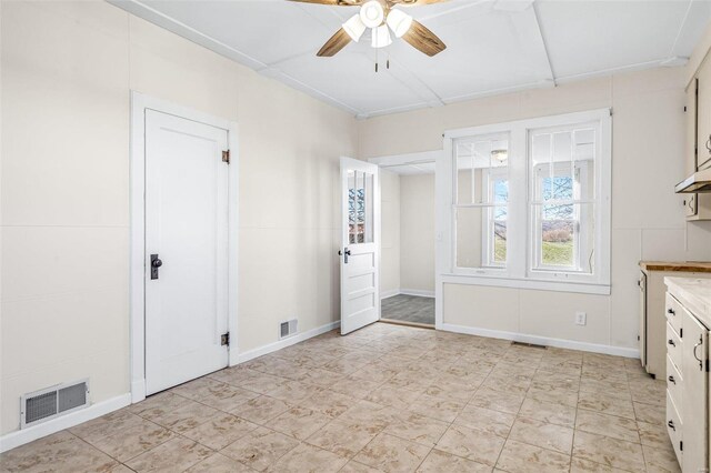 interior space with ceiling fan