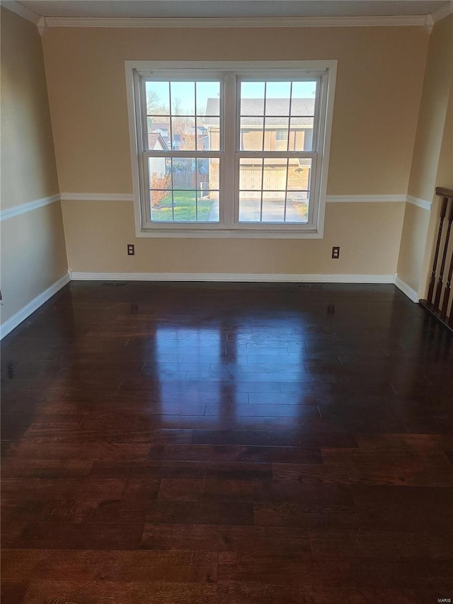 unfurnished room with crown molding, plenty of natural light, and dark wood-type flooring