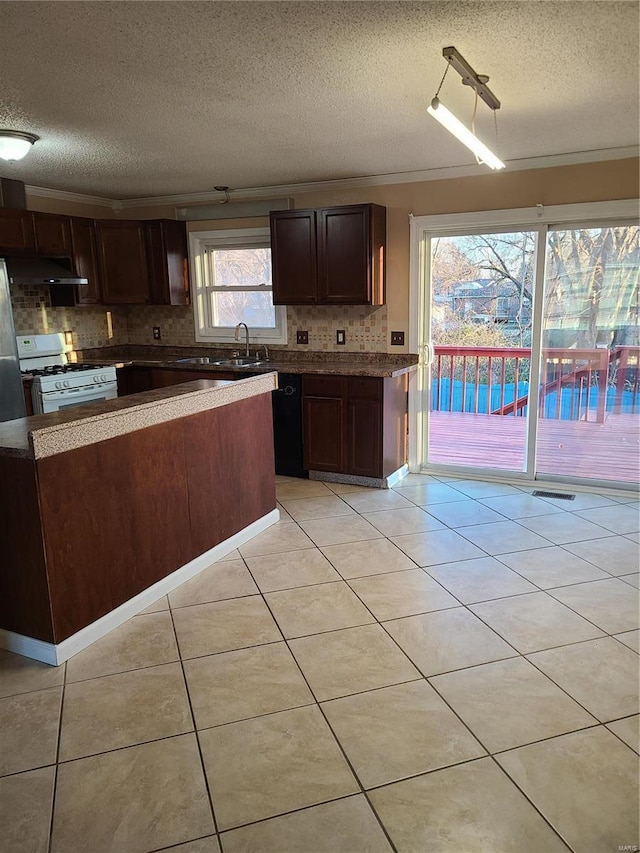 kitchen with white gas range oven, ornamental molding, a textured ceiling, sink, and light tile patterned flooring