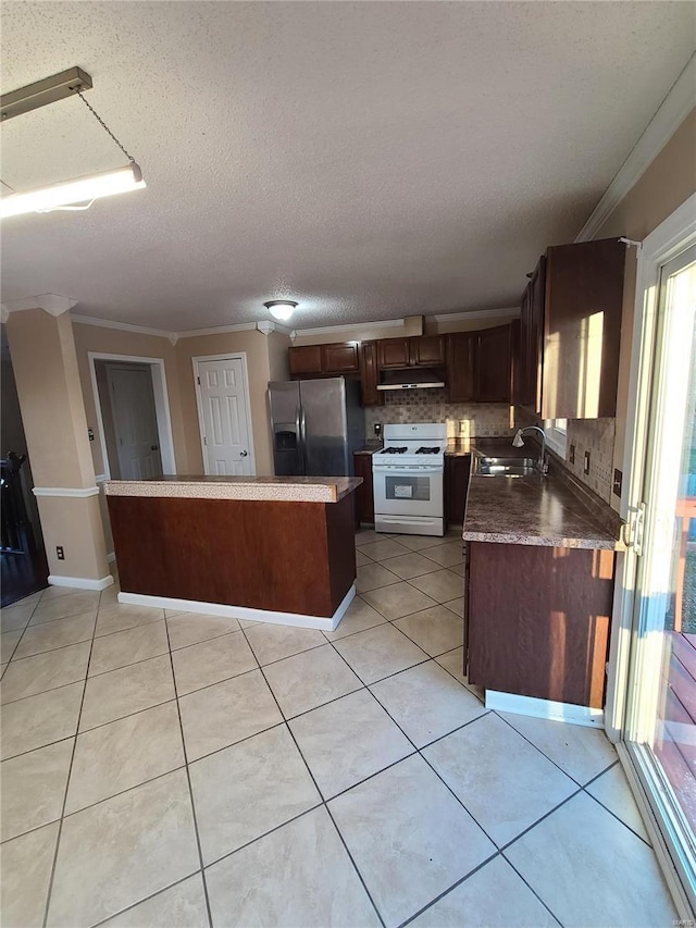 kitchen featuring stainless steel fridge with ice dispenser, light tile patterned floors, white gas range, and sink