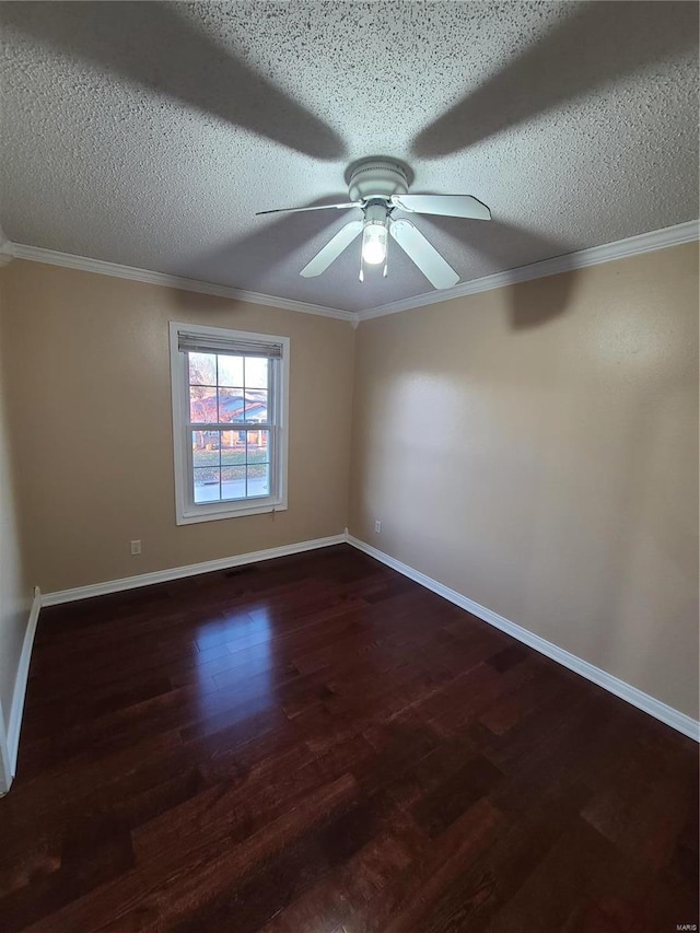 spare room featuring ceiling fan, dark hardwood / wood-style flooring, a textured ceiling, and ornamental molding