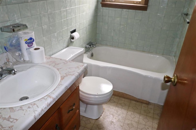 bathroom featuring vanity, toilet, and tile walls