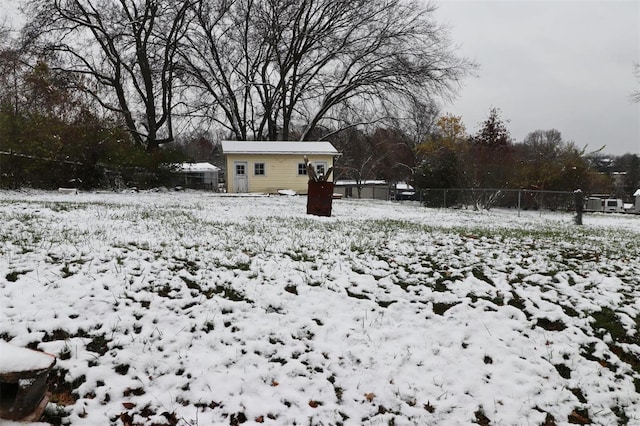 yard covered in snow featuring an outbuilding